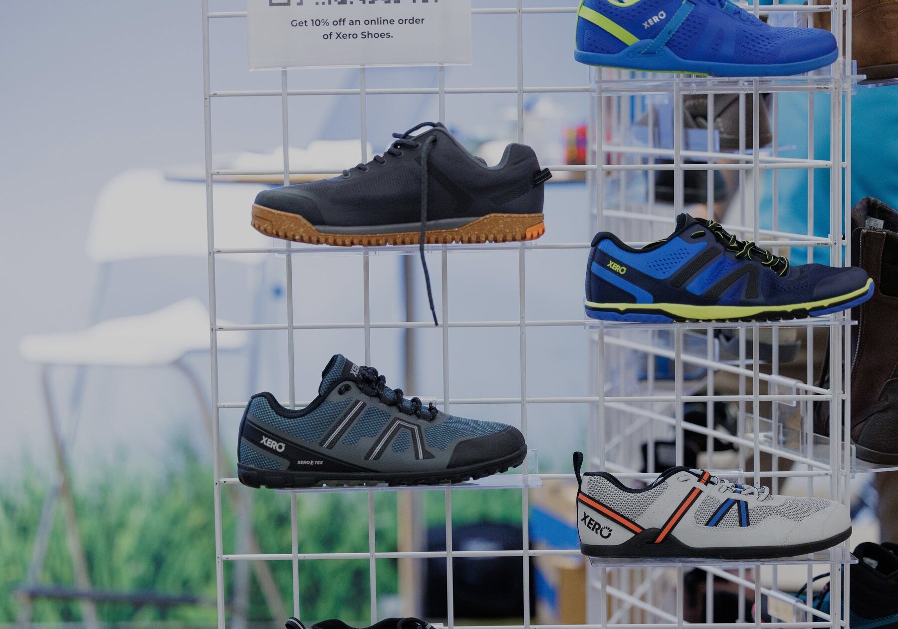 Barefoot trainers displayed on a metal rack at an exhibitor stand, photo by Barefoot Shoe Expo