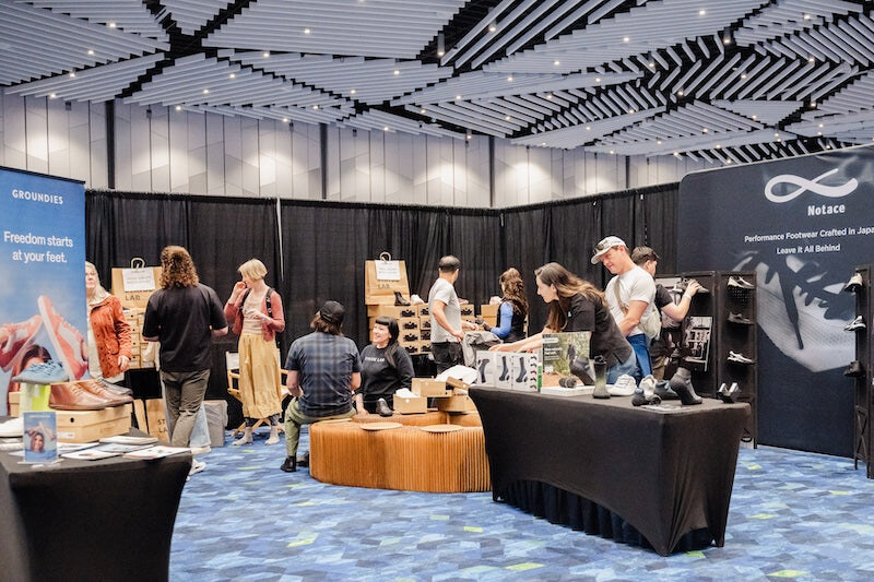 Visitors browsing footwear stands in the convention centre, photo by Barefoot Shoe Expo
