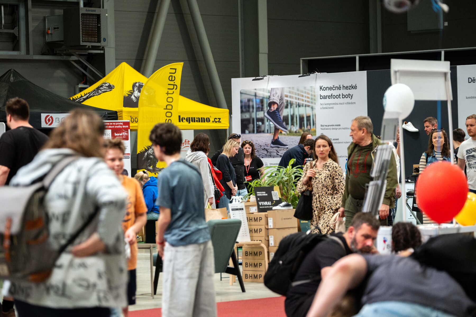 Visitors browsing barefoot shoe stands in the Prague exhibition hall, photo by Barefoot Expo Prague