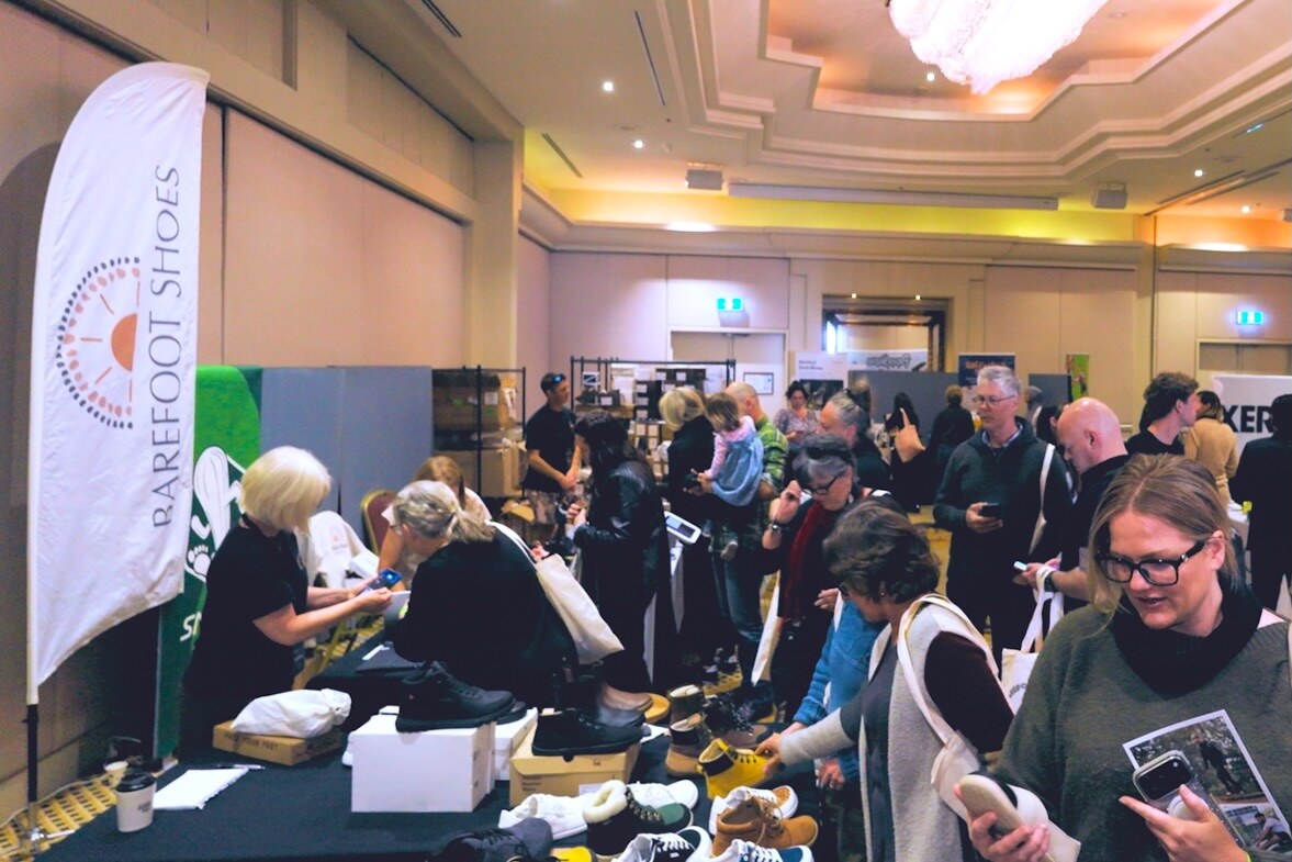 Visitors browsing footwear in the busy hotel ballroom, photo by The Foot Collective