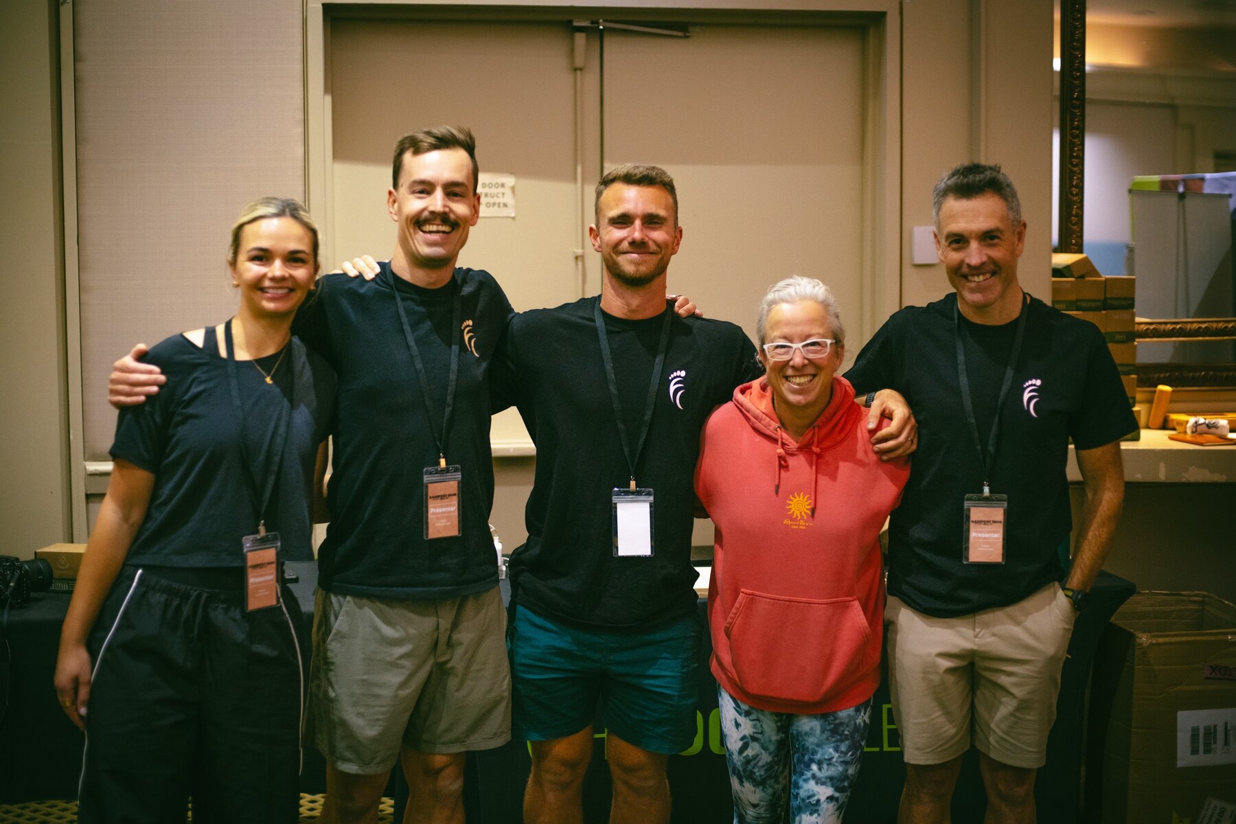 A group of attendees posing together in the hotel, photo by The Foot Collective