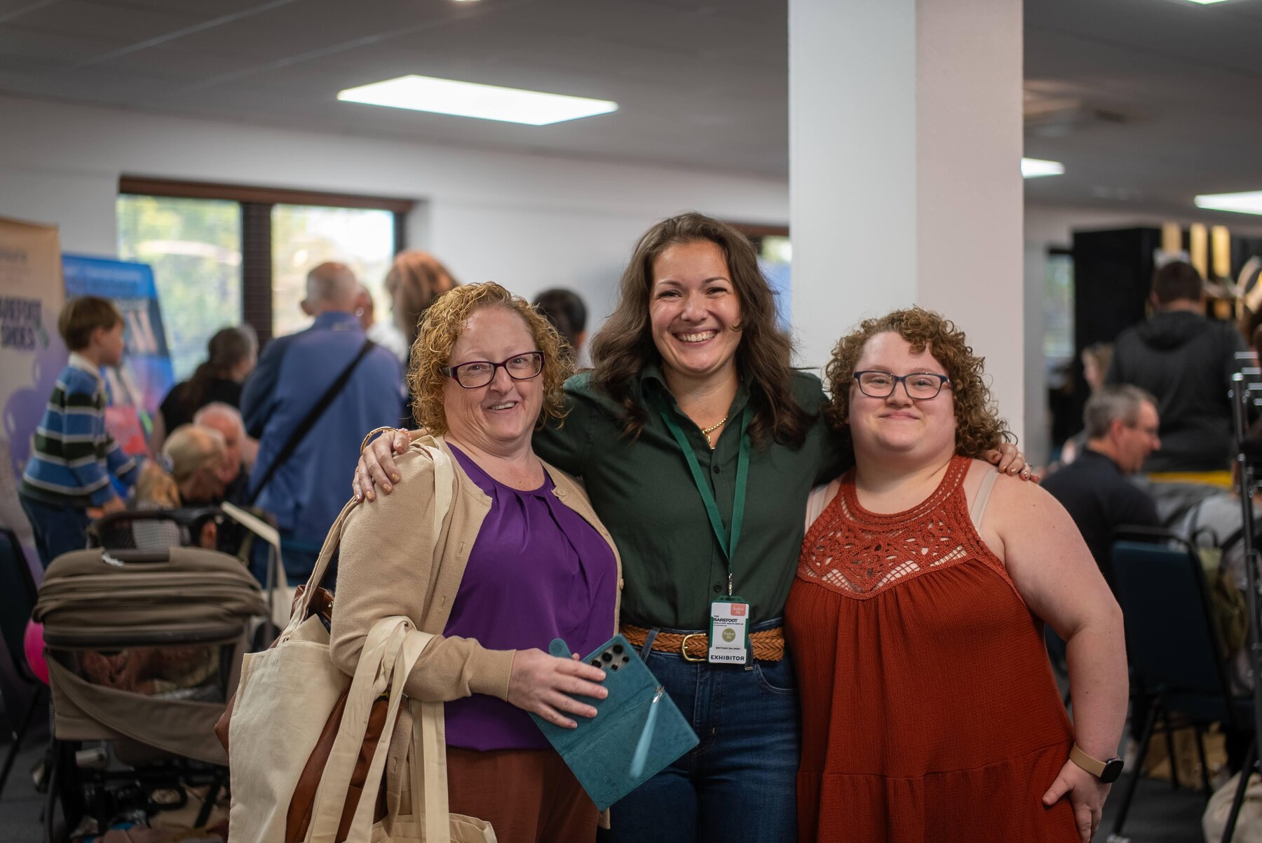 Three visitors posing together with their shopping bags, photo by Barefoot Brit Expo